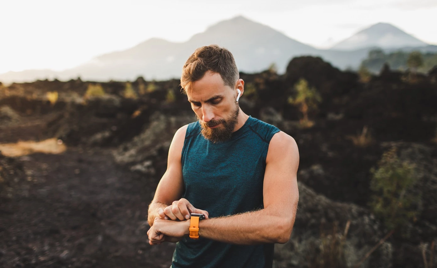 An athlete checking their watch before taking Anadrol.